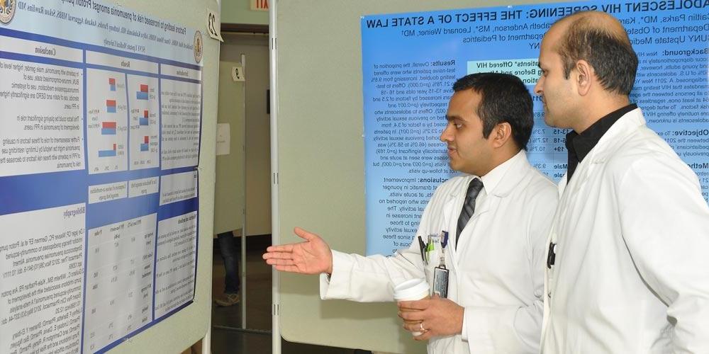 Residents Discussing Research Poster